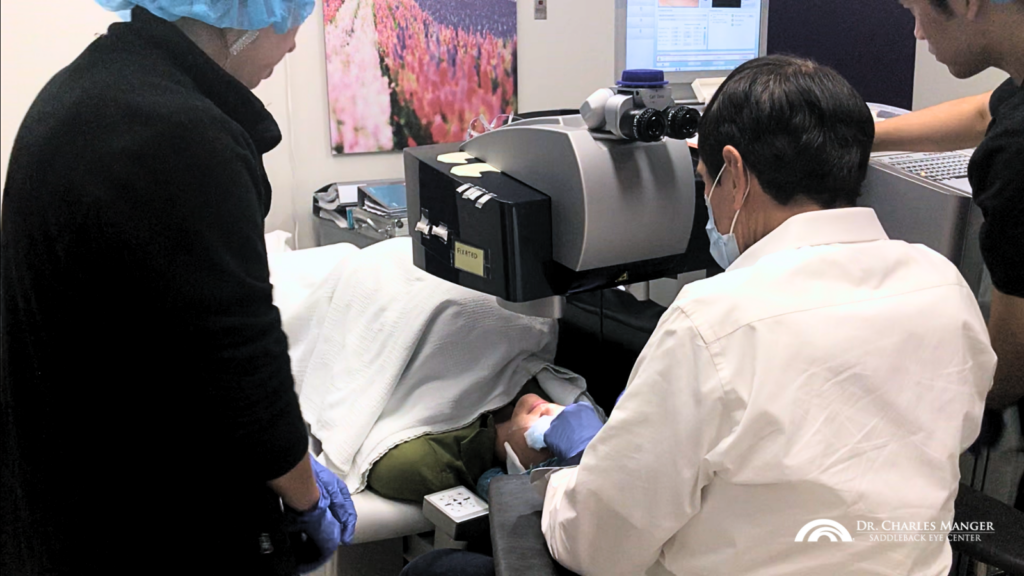 LASIK eye surgery expert Dr. Manger in the process of conducting LASIK surgery on a patient.