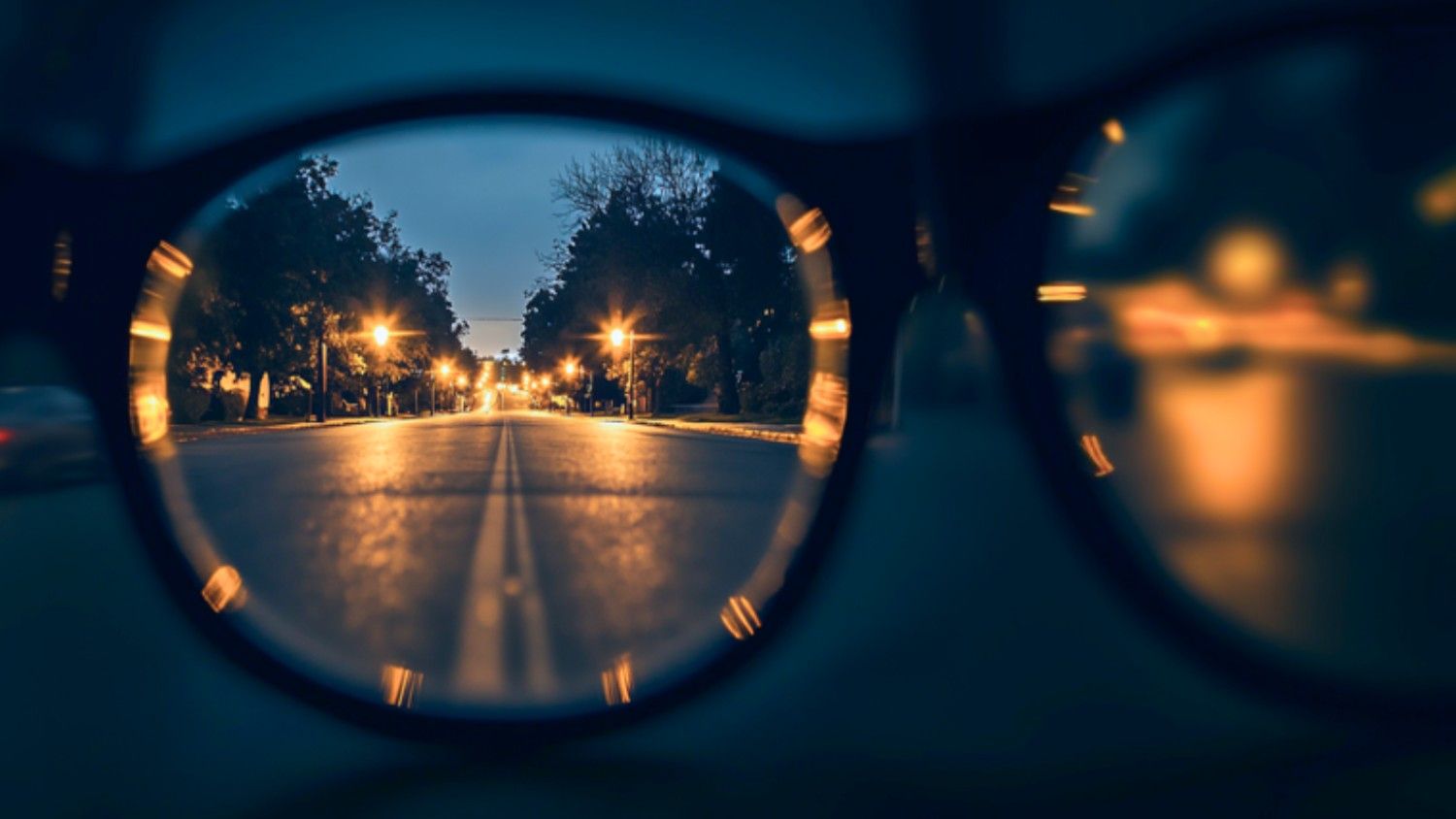 a nightscape view from the perspective of a person with night vision impairments driving in the evening